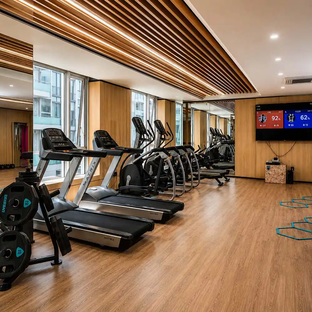 fitness center cardio area with walnut veneer wall panels column cladding and wood ceiling details