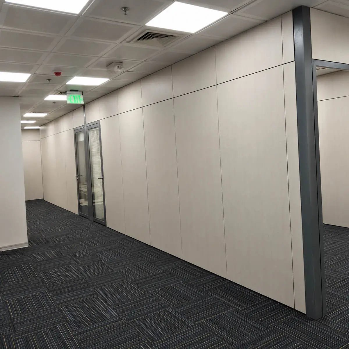 SG-100 demountable wall corridor installation with wood-finish solid panels and grey-framed glass doors