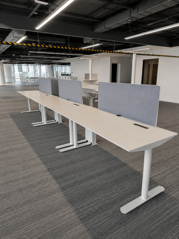 project specific karen workstation setup with height adjustable bases central screens and integrated cable openings
