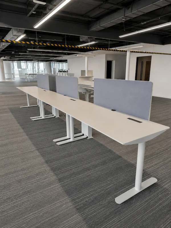 project specific karen workstation setup with height adjustable bases central screens and integrated cable openings