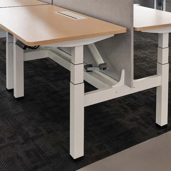 close up of a milan height adjustable workstation with three stage lifting columns an adjustable beam control keypad and fabric screen
