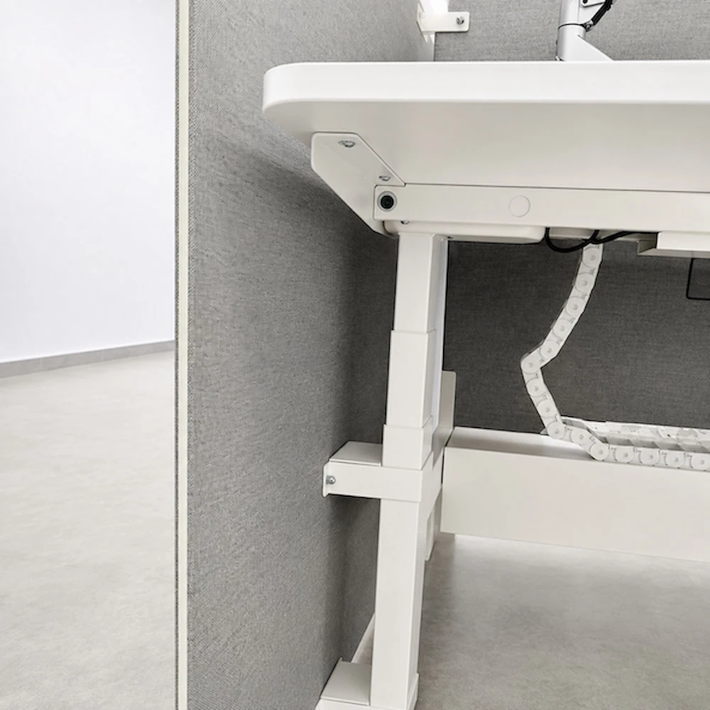 close up of milan height adjustable workstation with lifting column cable chain and desk screen