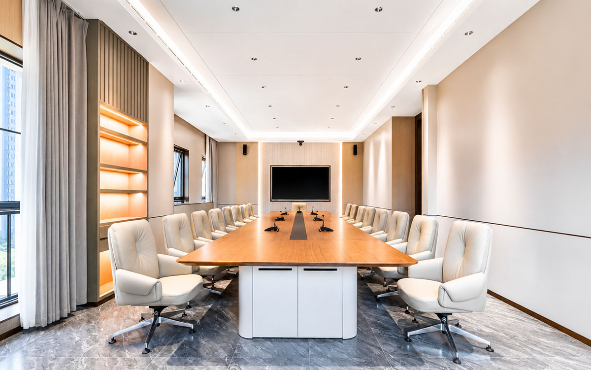 Modern conference room with a large meeting table and office chairs