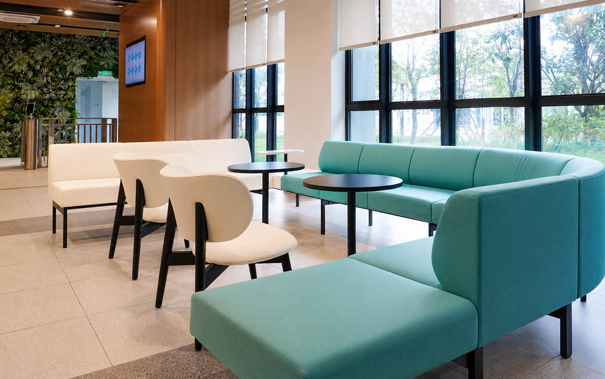 Office lounge area with sofas, chairs, and occasional tables