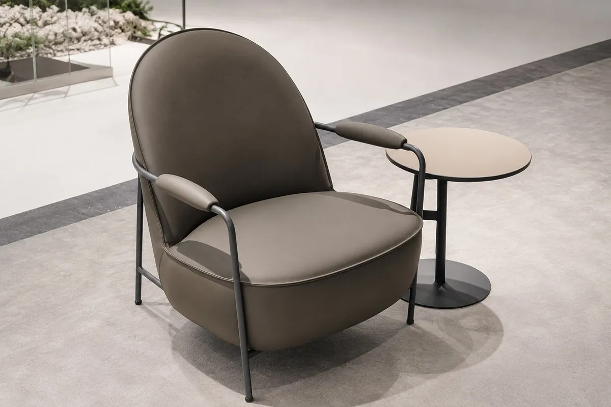 Upholstered office lounge chair with metal frame and integrated armrests