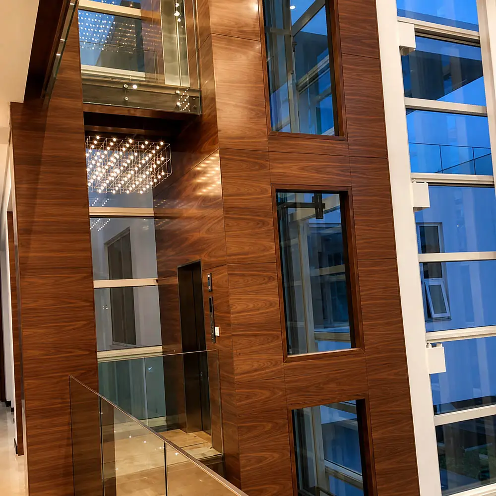 wood finish wall and column cladding beside glass partitions in a commercial interior