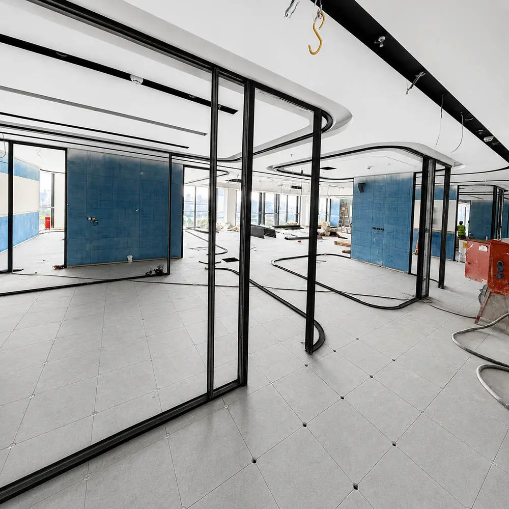 black framed glass partition system installed in an office interior during construction