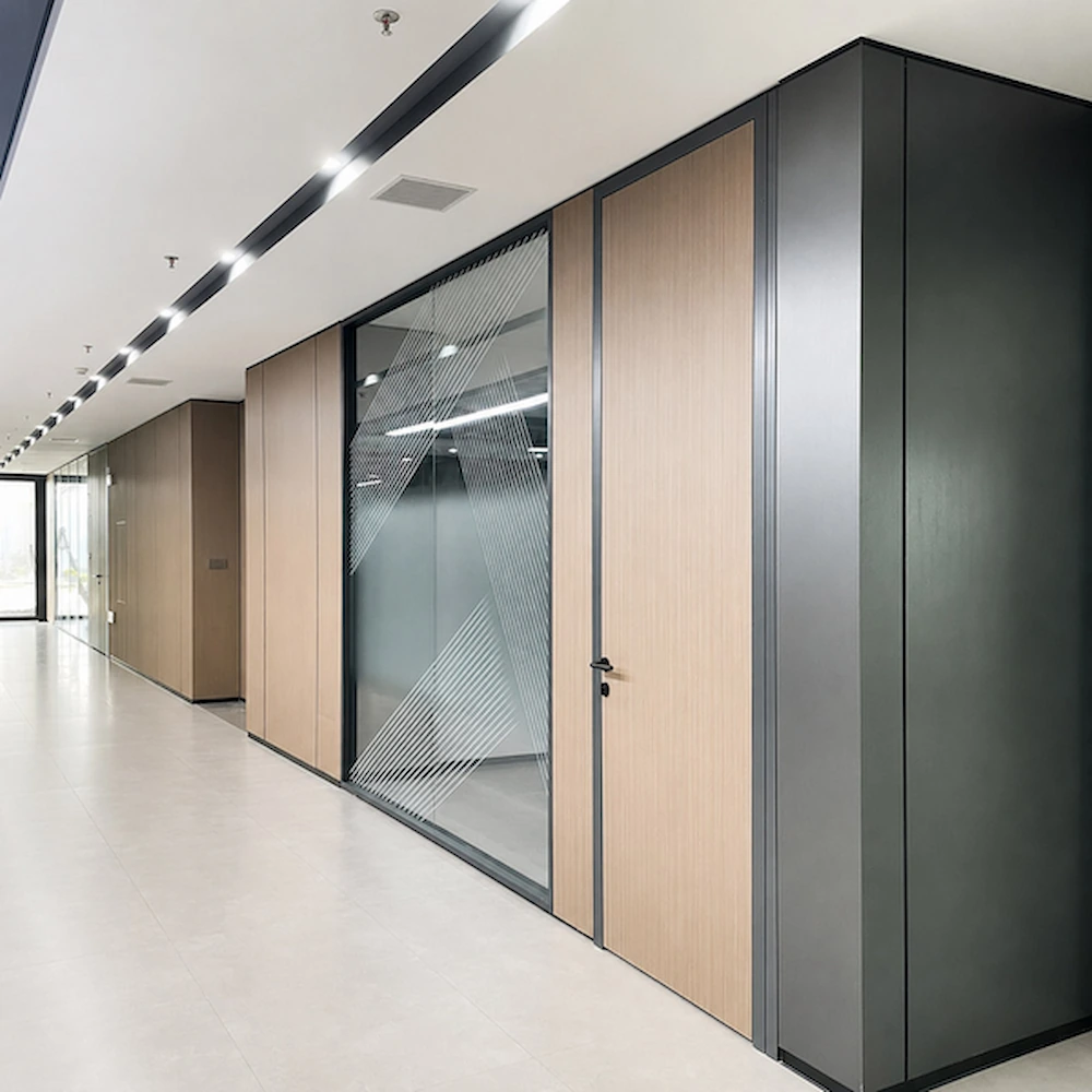 meeting room glass wall with glass panels wood look solid sections and privacy graphics along an office corridor