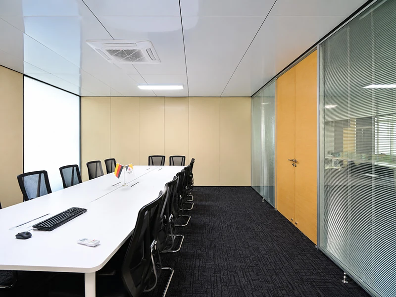 glass office partitions with blinds beside a modern meeting room