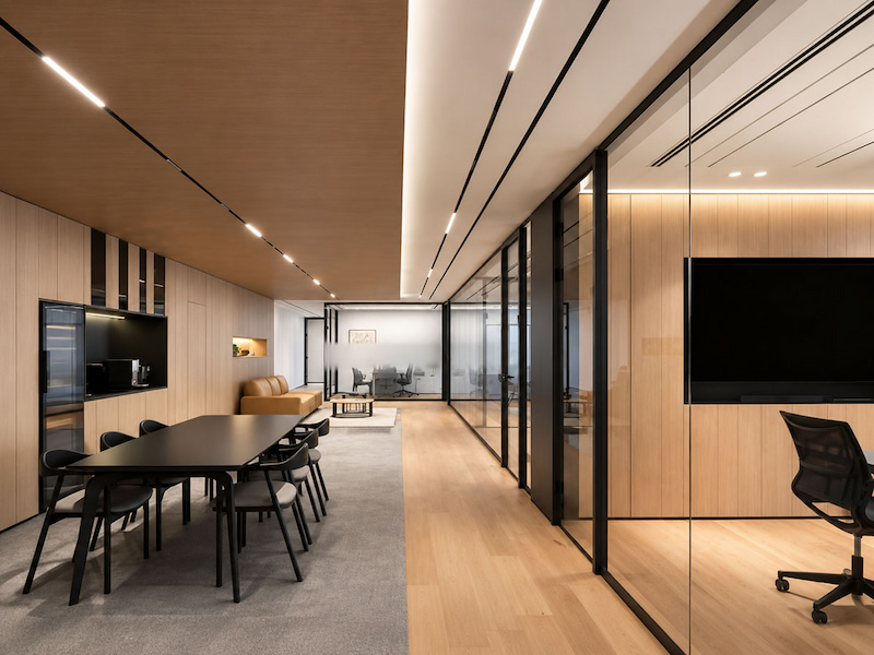 office glass partition separating meeting and work areas with visual continuity