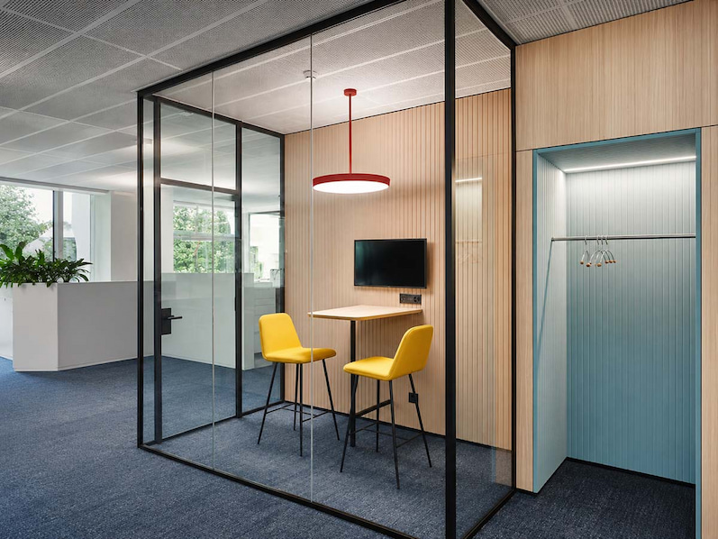 transparent collaboration room with slim framed glass partitions in a modern office