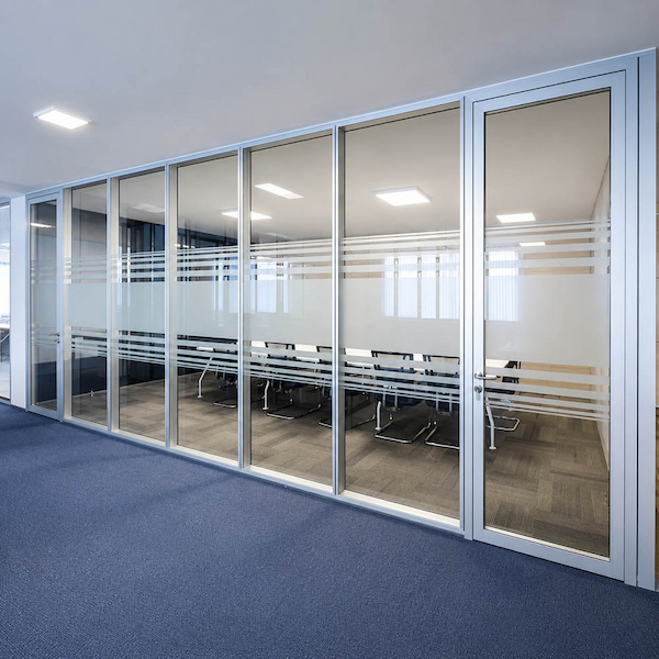 full height framed glass partition enclosing a meeting room with a glass door and privacy bands