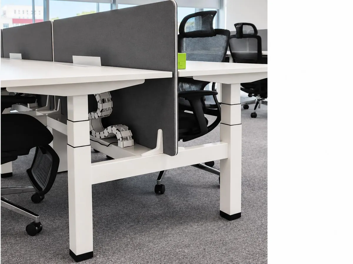 height-adjustable desk frames with lifting columns in a modern office