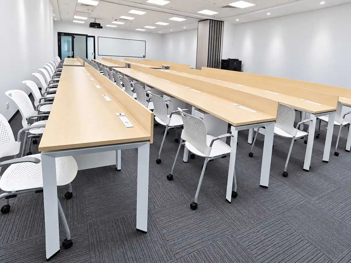 fixed-height desk frames and table bases arranged in a commercial workspace