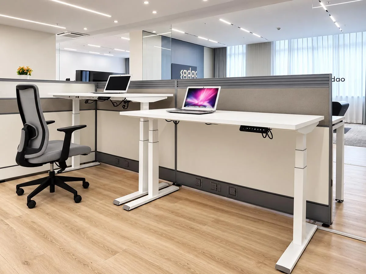 height-adjustable desk frames in a modern office with workstation screens