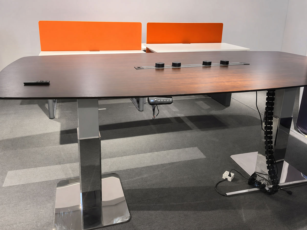 height adjustable conference table with visible handset tabletop access points and moving cable chain for power and data planning