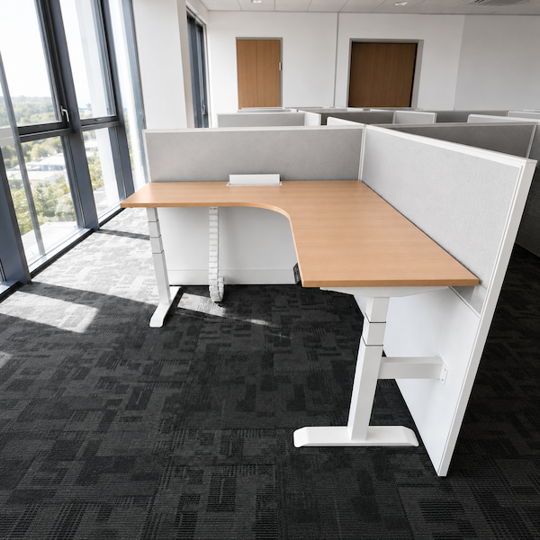 installed l shaped height adjustable desk showing the cable management chain and handset