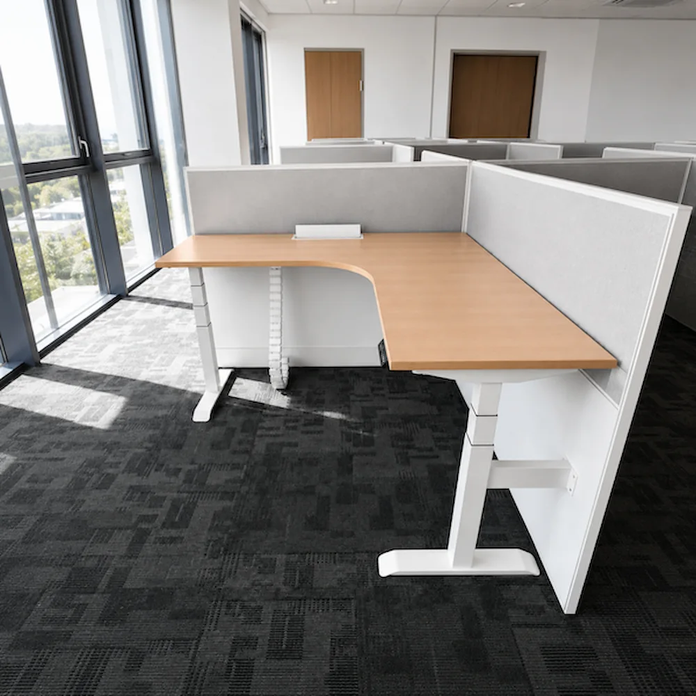installed l shaped height adjustable desk showing the cable management chain and handset