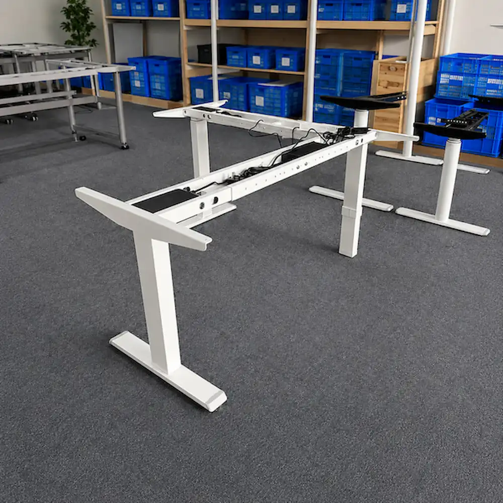 three leg l shaped height adjustable desk frame showing the main and return frame structure