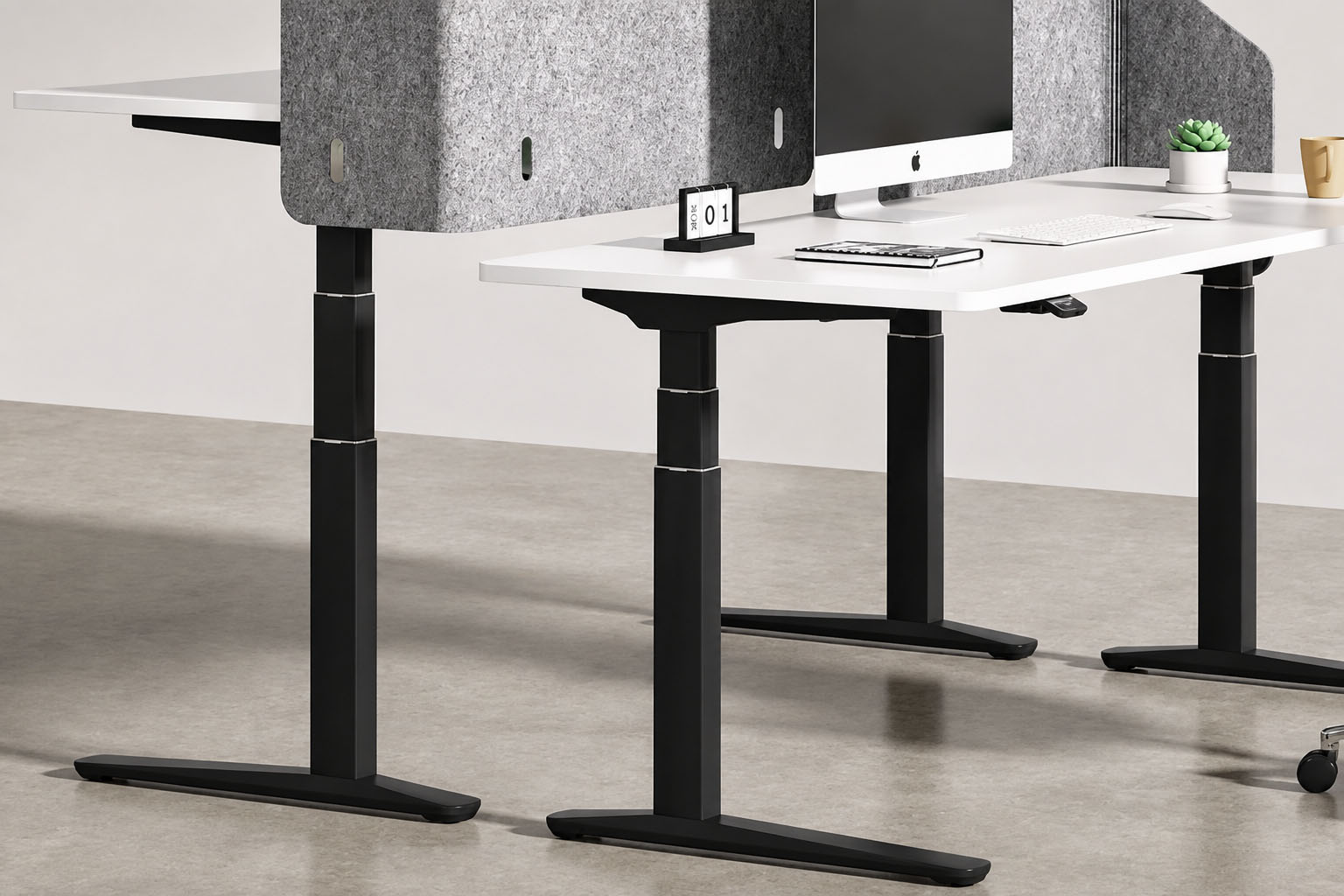 black three stage height adjustable workstation with privacy screens and multiple desks