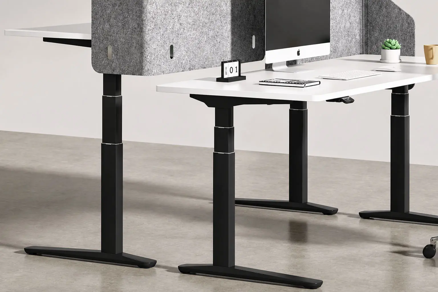black three stage height adjustable workstation with privacy screens and multiple desks