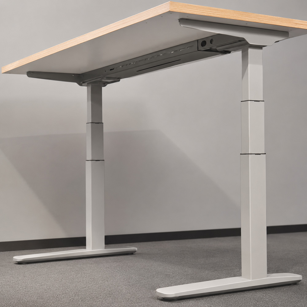 white three stage height adjustable desk frame viewed from below the desktop