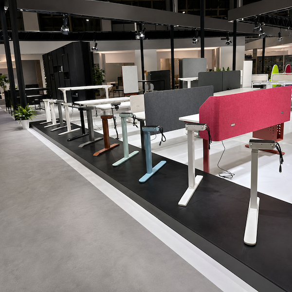 showroom display of height adjustable desk frames and workstation configurations for comparison review