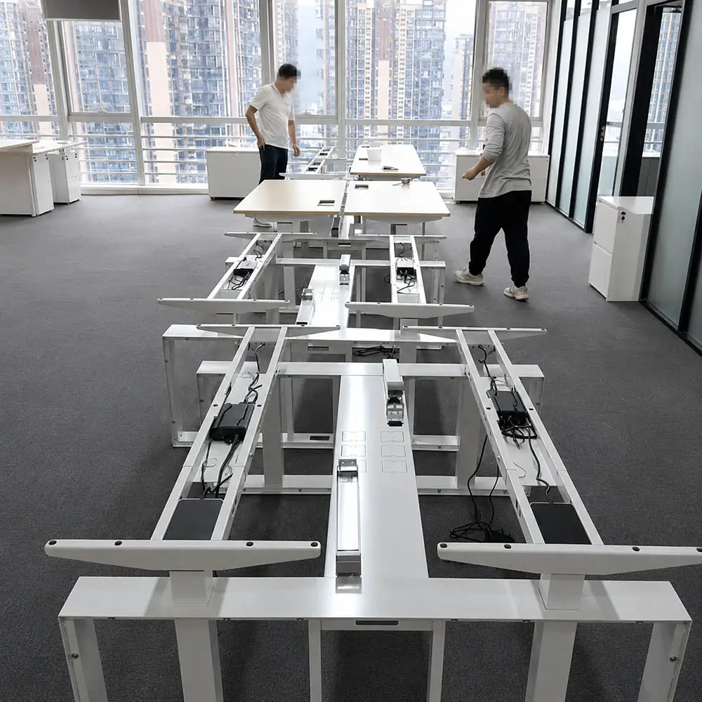 standing desk frames being checked before tabletop installation in an office project area