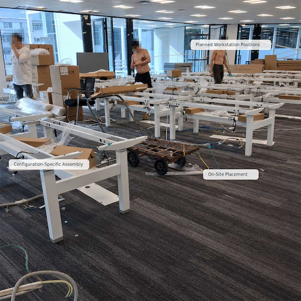 height adjustable workstation groups being assembled in a multi seat office project