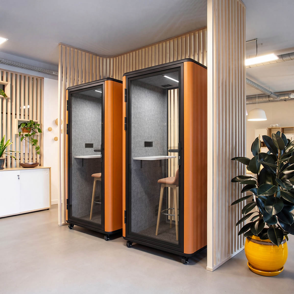 Pair of 1P office pods placed near a circulation zone with walkway access
