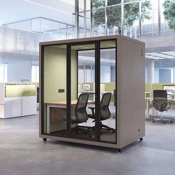 two person glass meeting pod with a table and chairs in an open plan office